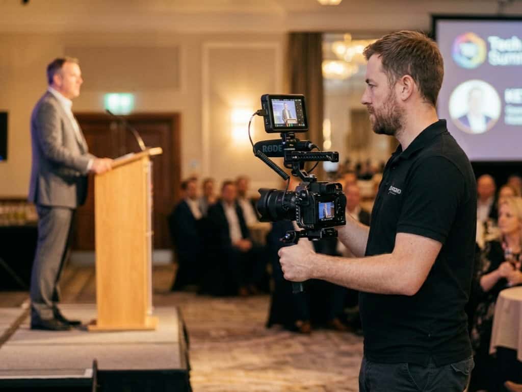 Perfect Cadence Events – Conference Recording Professional videographer filming at a corporate event or conference.