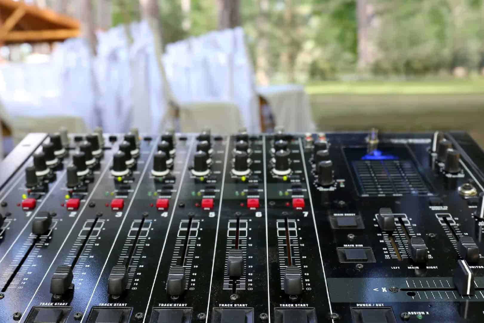DJ mixing console at outdoor wedding event for memorable celebrations.